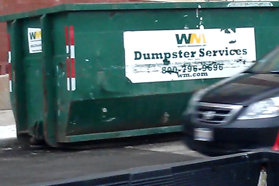 A dark green WM container with a white panel carrying the green WM wordmark and gold swoosh